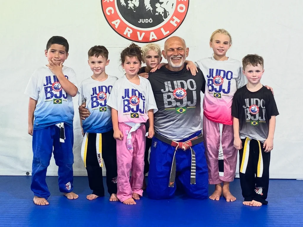Young athletes practicing Brazilian Jiu-Jitsu ground techniques